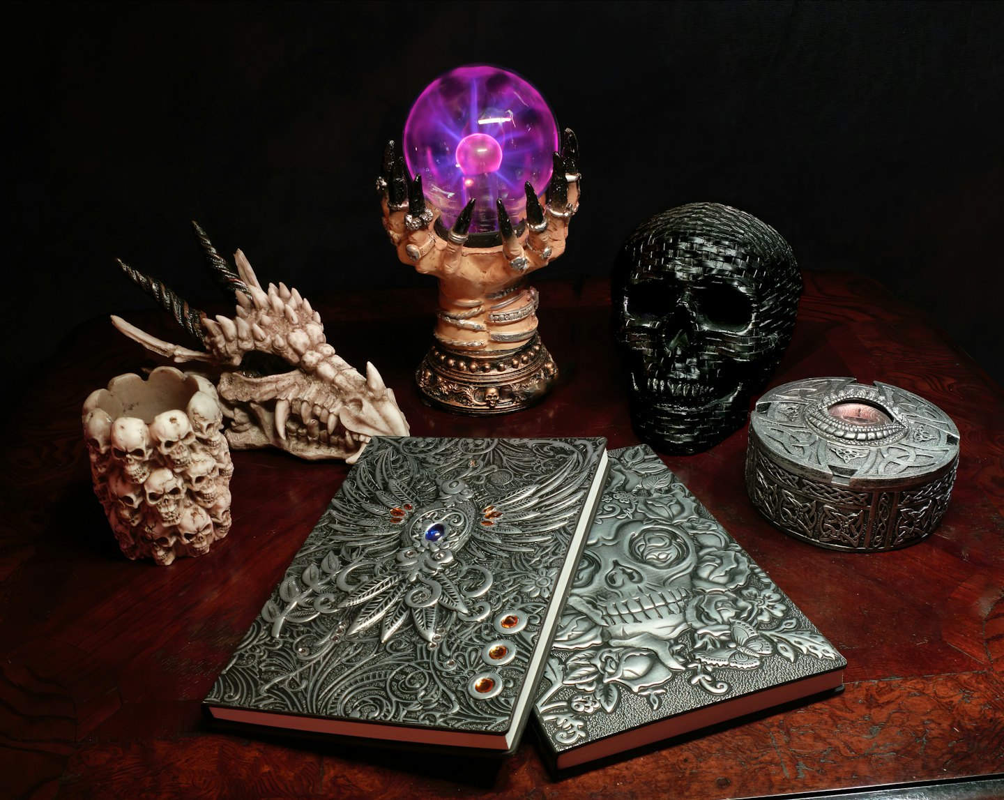 Gothic decor including plasma ball, skull sculpture, and dragon skull.