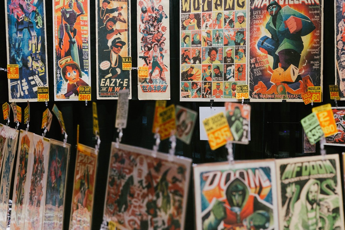 Wall display of vintage pop culture and music art prints.