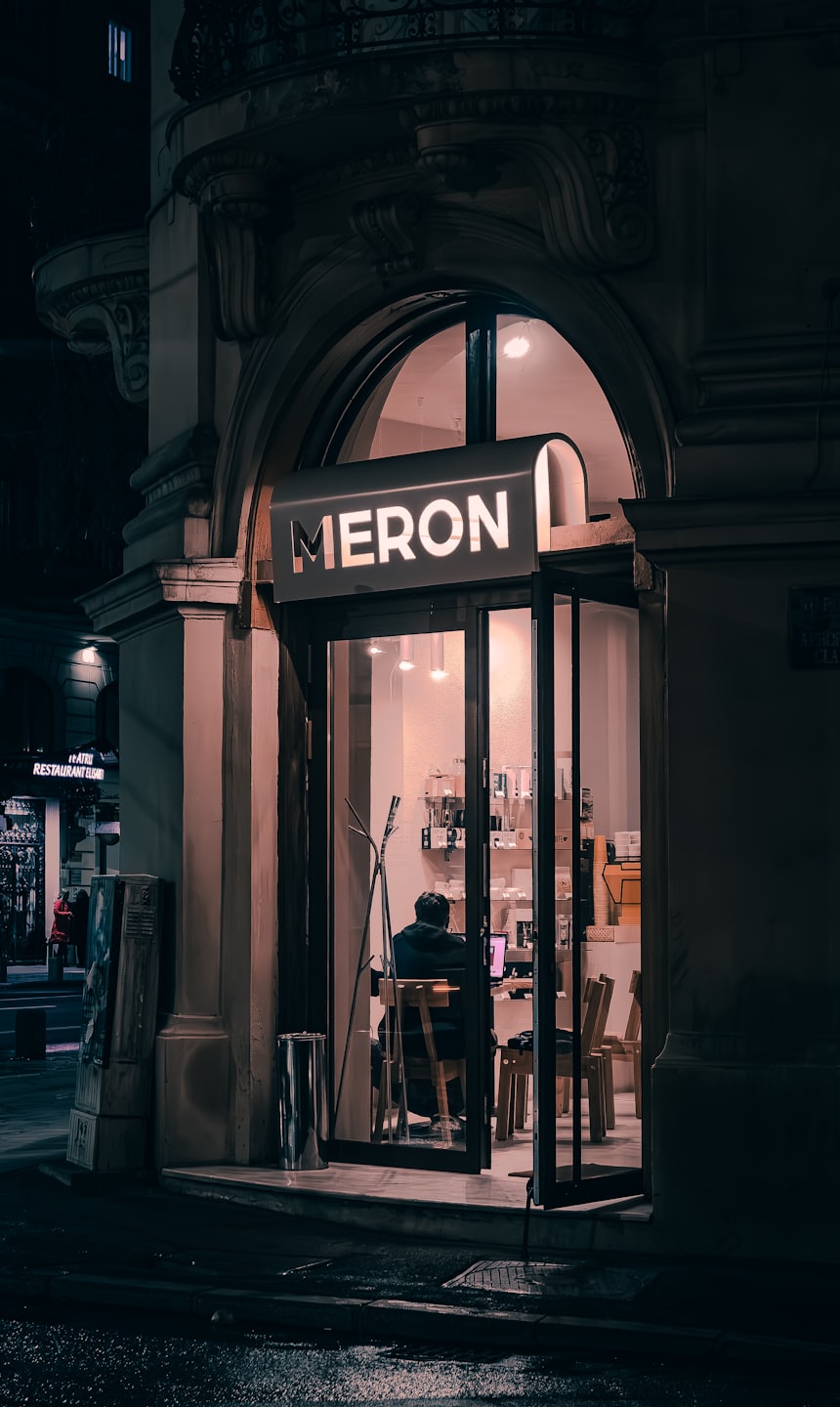 A person works on a laptop inside the Meron storefront.